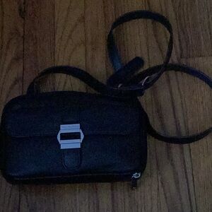 Black Leather woman’s Crossbody Bag..  9/6. Pockets in front and back of bag..